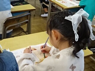 写真:鉛筆を持って文字を書く1年生