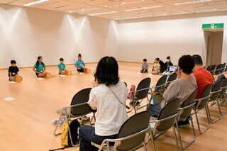写真：発表する子ども達と見守る保護者