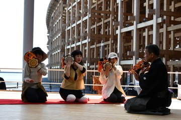 写真：小鼓を体験している女性3人