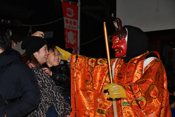 鬼追い神に頭を撫でられる子ども