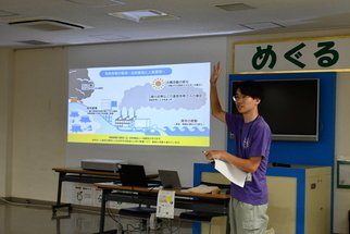 地球温暖化に関する説明を行う職員