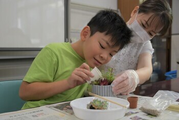 多肉植物の寄せ植えに取り組む親子